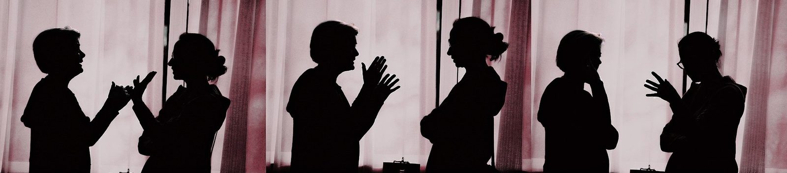 A row of silhouettes, two people in conversation