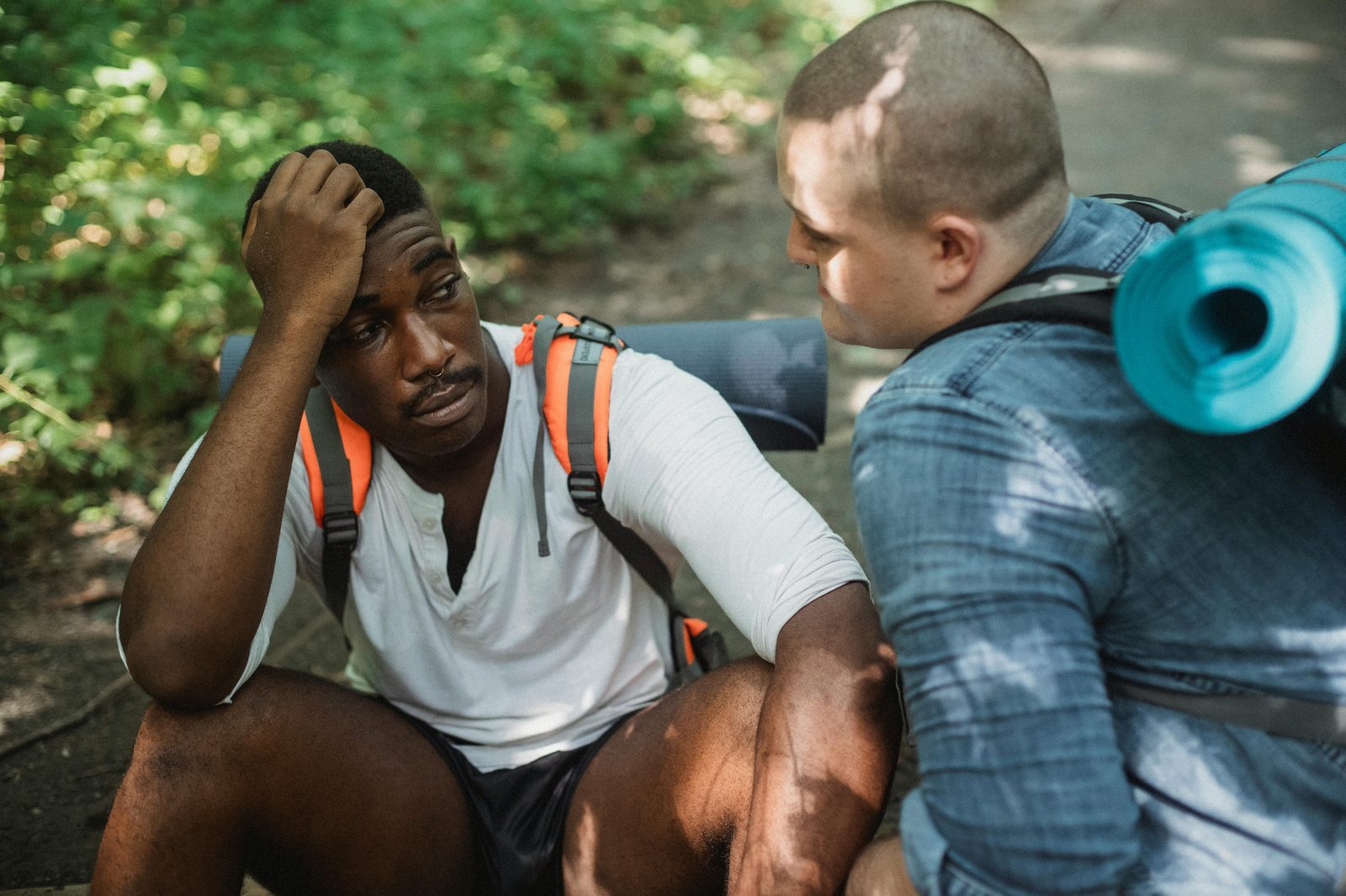 Two hikers pausing so one can check on the other