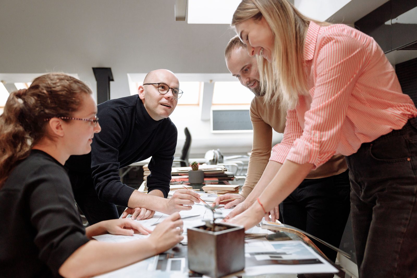 A team gathered around a table working through a problem together